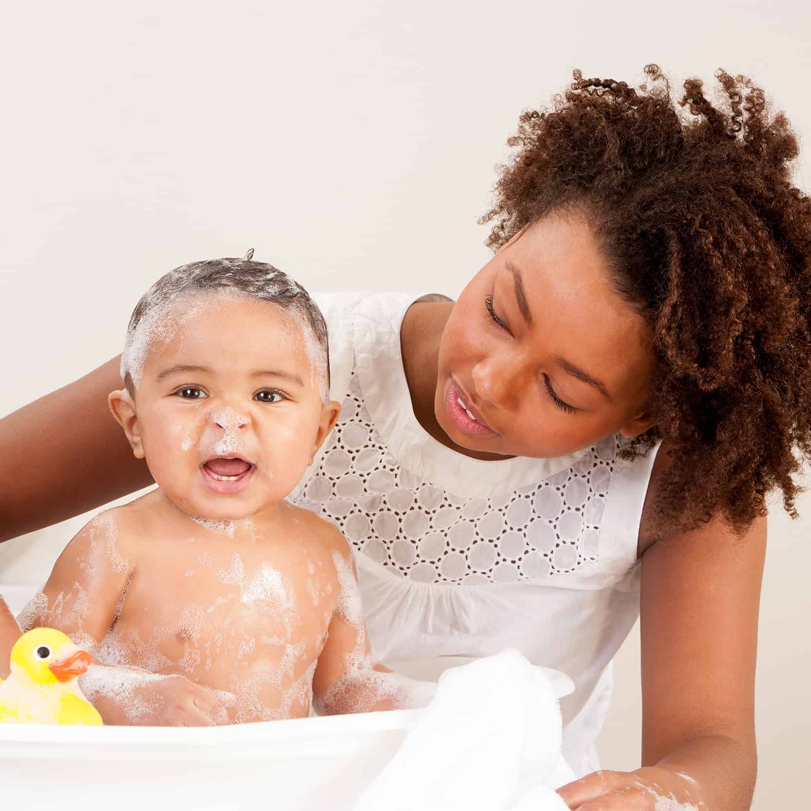 Mom providing healthier bath for baby with a whole house water filter