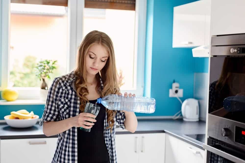 Woman enjoys best-tasting home water with whole house water filters