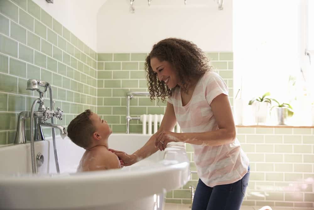 Mom giving healthier bath to son with home water softener system